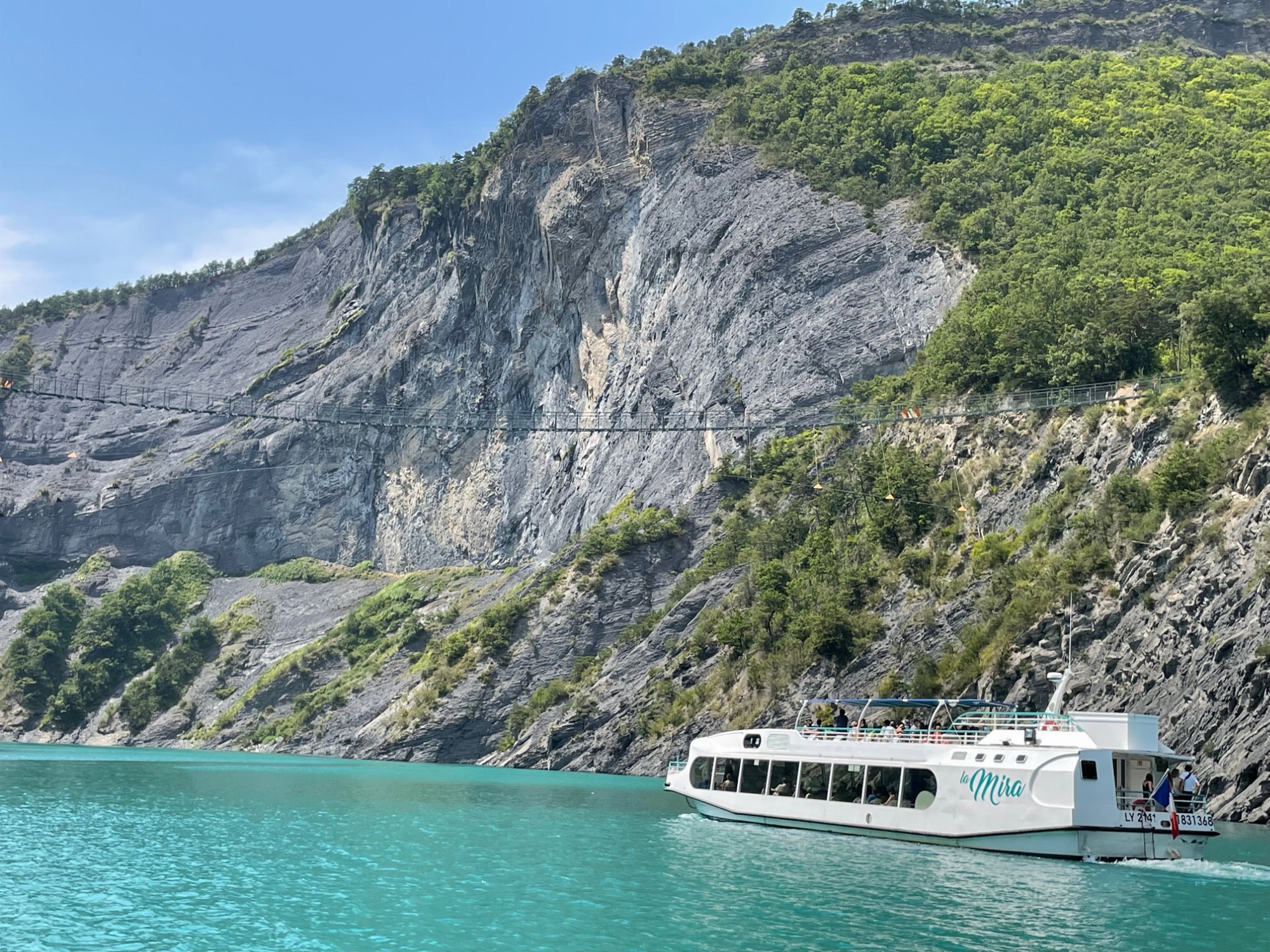 Bateau la Mira sur le lac de monteynard avec vue sur la passerelle himalayenne