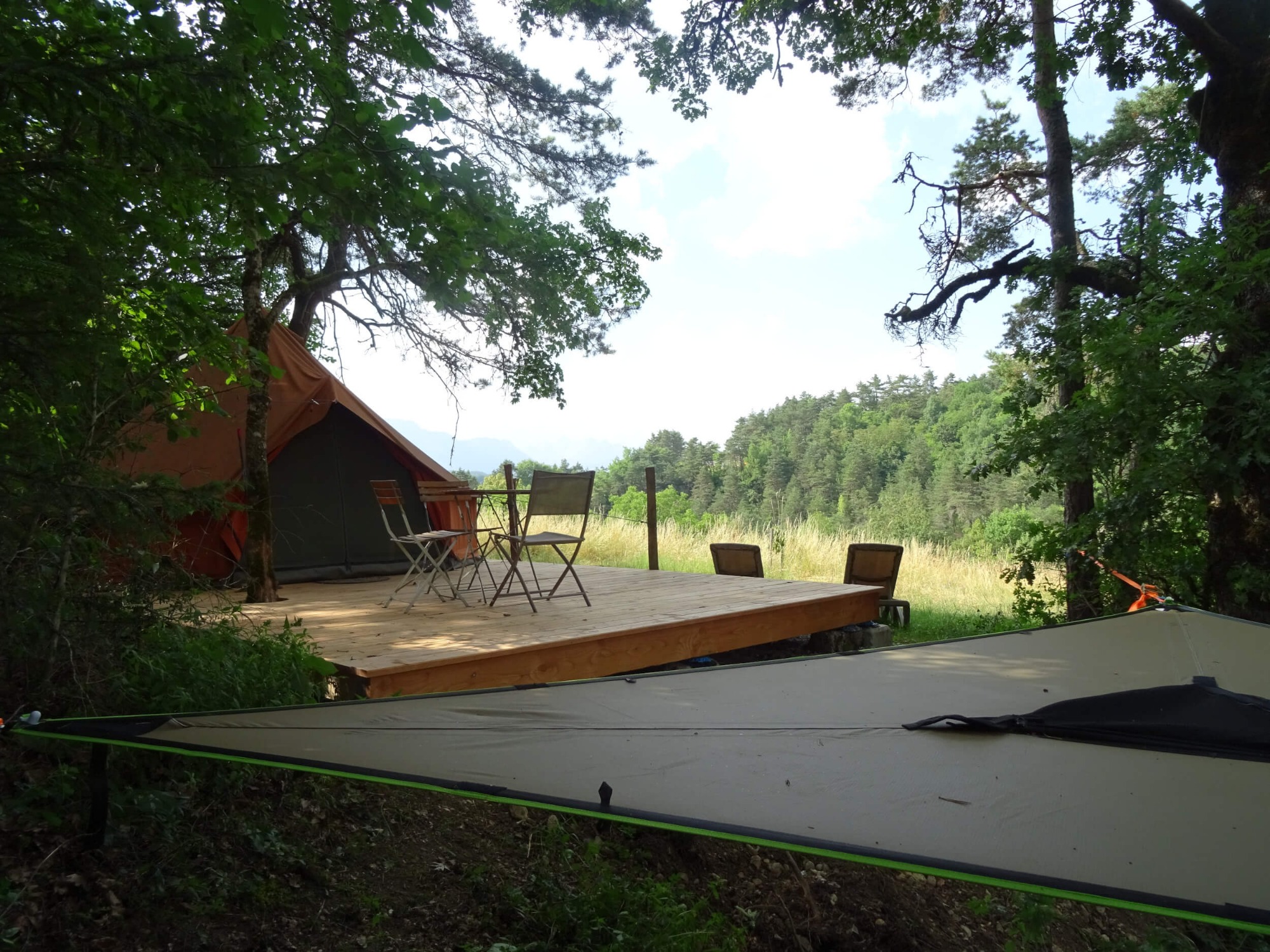 Tente nomade avec hamac perché dans les arbres au Moulin de Recours